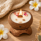Bougie Luminante Fleur de Tiaré allumée, pétales roses séchés et petits coquillages sur la cire