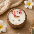 Bougie Luminante Fleur de Tiaré dans son contenant en noix de coco, pétales séchés et petits coquillages sur la cire